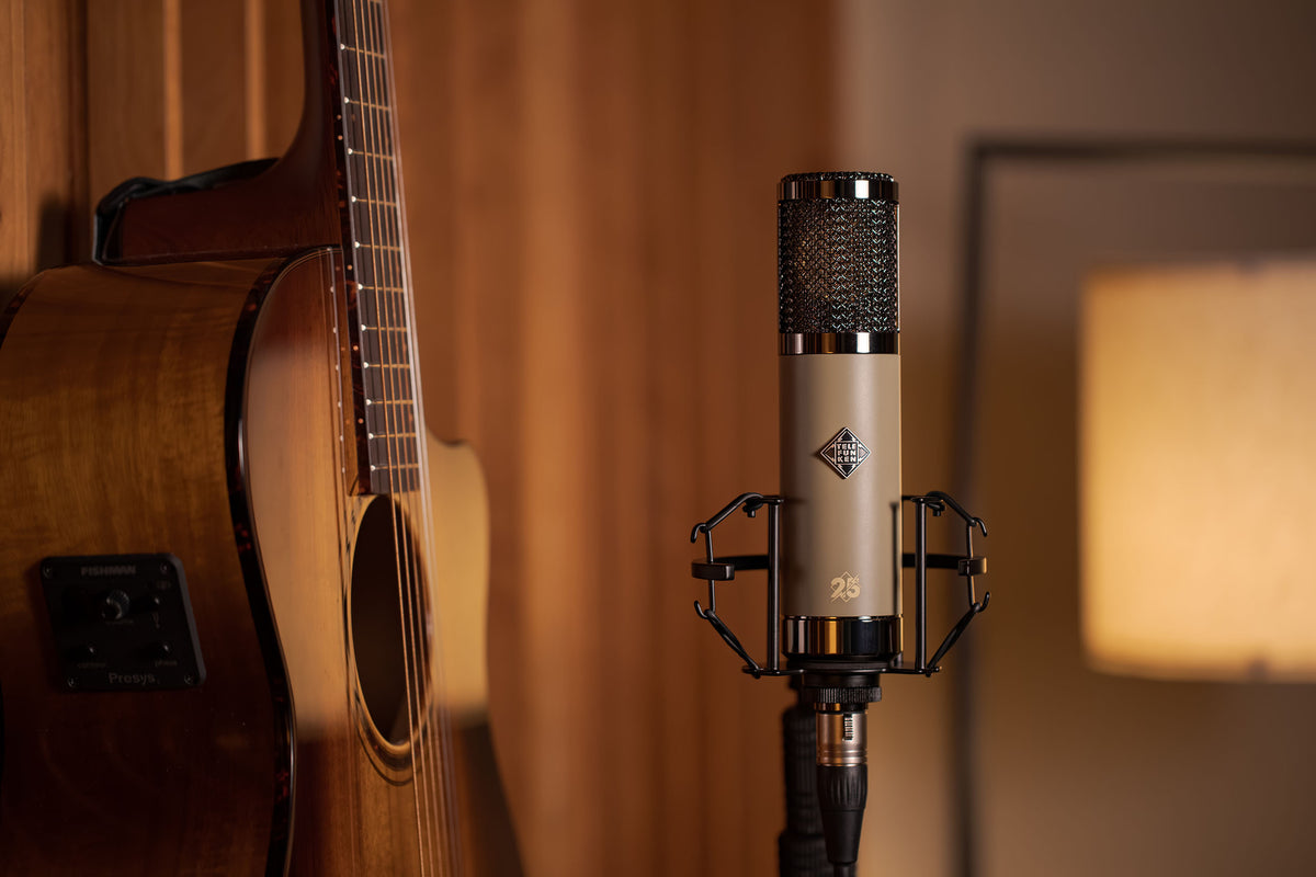 Telefunken TF51 25th Anniversary Edition mounted beside an acoustic guitar in the studio